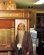 Japanese calligrapher master Kampo Harada, who believes himself to be of the Zevulun tribe, in front of the ark in his Kyoto home